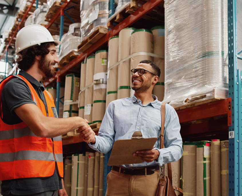 Logistics Worker Sharing Handshake With Businessperson
