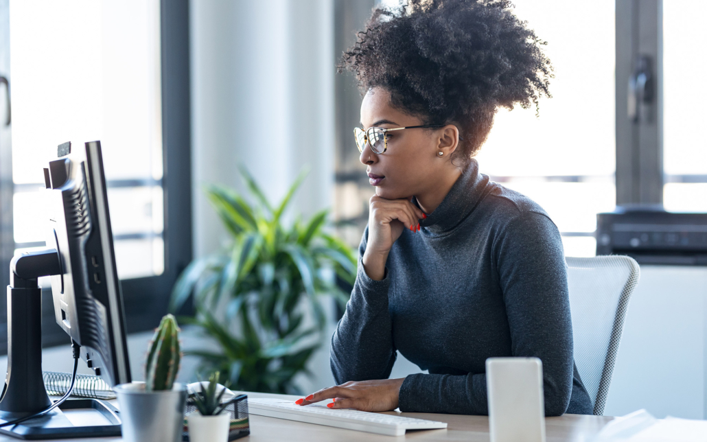 Business Woman Working While Making Video Call With Computer Sitting In The Office