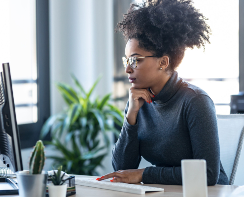 Business Woman Working While Making Video Call With Computer Sitting In The Office