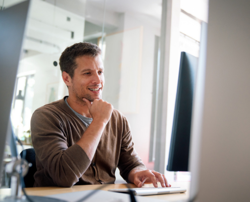 Programmer, Web Developer, Designer Working At Office Comparing Mobile And Desktop