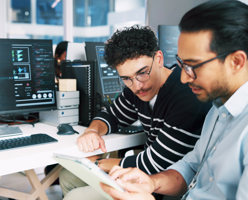 Tech Workers Looking At Information On Tablet