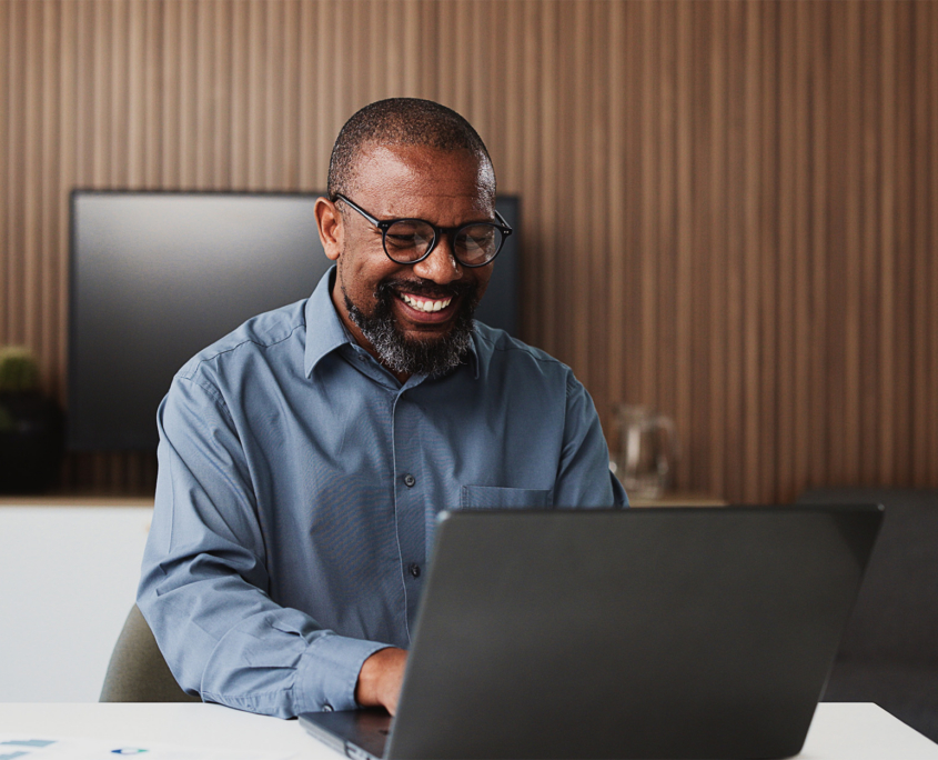 Smiling Lawyer Using A Laptop In Office